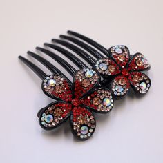 ALL ORDERS PLACED BETWEEN 12/9- 12/15/ WILL SHIP ON 12/16. THIS IS THE LAST DAY TO SHIP TO ARRIVE BY CHRISTMAS DAY. This stunning red plastic hair stick/fork comb is the perfect solution for women who love to use their hair up in beautiful updos. Its lightweight design makes it ideal for thick or fine hair, and it's the perfect styling assistant for busy women who want to look their best. Whether you're the mother of the bride or groom, a bridesmaid, or simply someone who loves to accessorize, this comb is the perfect addition to your hair accessory collection. With its versatile design, it can be used as a hair stick or a hair fork, and it's perfect for creating French twists, buns, and other beautiful hairstyles. Measures: L 4.33 inches x 3.93 Inches H Red Hair Accessories, French Twists, Floral Comb, Hair Accessories Collection, Beautiful Hairstyles, Busy Women, French Twist, Hair Stick, Crystal Accessories