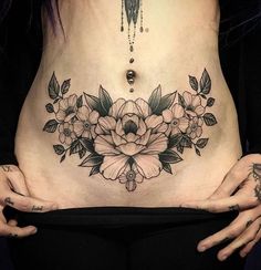 a woman is holding her stomach with flowers on it