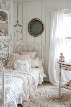 a white bed sitting in a bedroom next to a window