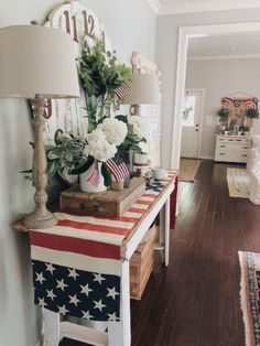 a living room filled with furniture and flowers on top of a flag table cloth covered bench