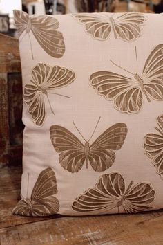 a pillow with brown butterflies on it