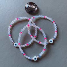 This elasticated beaded bracelet is made from 4mm glass opal style beads and has multi coloured seed beads. It has a glass evil eye in the middle. The spacer beads are gold seed beads. Please note all beads are unique and may vary slightly in colour and size shown. Also as with all crystal beads there may be very slight imperfections on the stones. This bracelet has dyed stones that may transfer on to skin if wet do be careful. Please take care of item and remove when washing etc. Make sure to avoid contact with water and fragrances etc.  As all my items are handmade please handle with care!  All my bracelets are made to a 7 to 7.5 inch length (which is the average female wrist size). If you require a different size please get in touch 💗 💜Orders containing multiple bracelets will be pack Bead Shoes, Holographic Bag, Summer Jewellery, Glass Evil Eye, Beaded Shoes, Multiple Bracelets, Eye Bracelet, Themed Jewelry, Evil Eye Bracelet