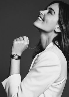 a woman wearing a white shirt and bracelet