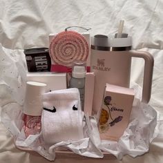 a basket filled with personal care items on top of a bed