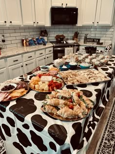 a table covered with lots of food sitting on top of a kitchen counter