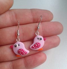 small pink bird earrings with white dots on them