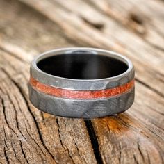 a wedding band that has been made to look like it is painted red and grey