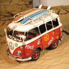 a small toy bus with surfboards on top