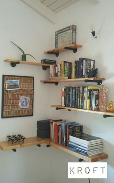 a bookshelf filled with lots of books next to a wall