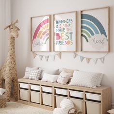 a nursery room with two giraffes hanging on the wall and several storage bins