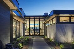 the entrance to a modern home at night