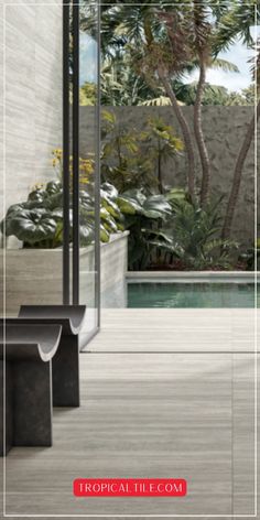 an outdoor area with a bench, trees and pool in the background text reads tropical tile com