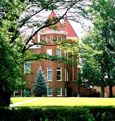 a large brick building surrounded by trees and bushes