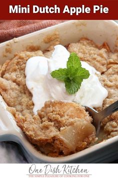 a close up of a dessert in a pan with ice cream and mint on top