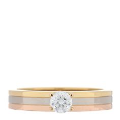 two tone gold and silver wedding ring set with a round diamond in the center, on a white background