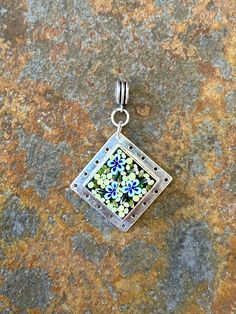 A beautiful statement piece, this pendant is handmade using individually cut tiny pieces of glass called "filate." My process is based on the ancient Italian technique of creating micro-mosaic jewelry - but with a modern twist. Signed and dated on the back. 1 1/16" x 1 1/16" Sterling silver over brass Chain not included Free shipping MIcro-mossaics are a special form of mosaic that use unusually small mosaic pieces of glass. The size of each piece can be a little as the lead in a mechanical pencil. Mosiac Jewelry, Mosaic Pendants, Handmade Glass Jewelry With Rectangular Pendant, Silver Glass Flower Pendant Jewelry, Handmade Glass Rectangular Pendant Jewelry, Handmade Square Glass Pendant Jewelry, Handmade Glass Square Pendant Jewelry, Silver Murano Glass Round Pendant Jewelry, Fused Dichroic Glass Pendant Necklace