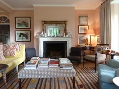 a living room filled with furniture and a fire place in the middle of a room