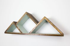 two wooden shelves with glass inserts on each shelf, one in the shape of a triangle