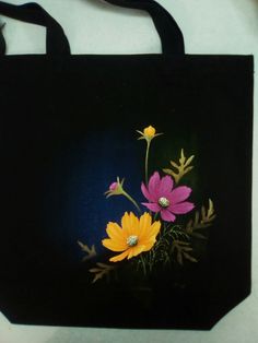 a black bag with flowers painted on it