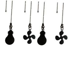 four black and white key chains hanging from the side of a wall with an object on it