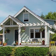 a small white house sitting on the side of a road