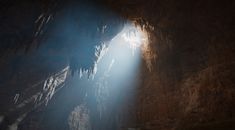 the light shines brightly through an opening in a cave