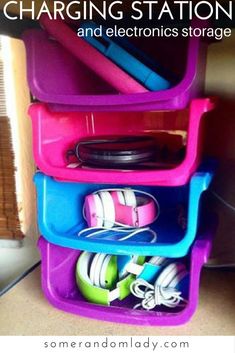 three bins stacked on top of each other with the words charging station and electronics storage