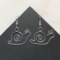 the earrings are made out of wire and have spiral designs on them