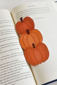 an open book with cut out pumpkins on it