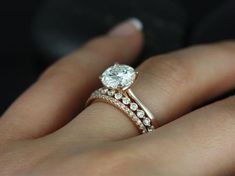 a woman's hand with a diamond ring on it