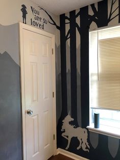 a room with a door, window and painted wall