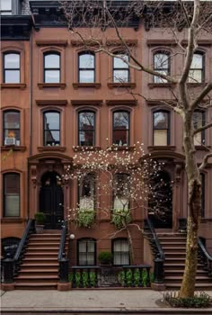 an apartment building with many windows and steps leading up to the front door is shown