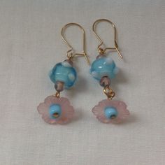 Lampwork glass flower earrings. Art glass and vintage lucite flower earrings on gold tone ear wires Dangle earrings for pierced ears Gold tone ear wires  Pink lucite flower petal with blue art glass and small Czech beads Roughly 1inch drop A great accessory for wedding guest and other great occassions Bohemian bride, vintage bride Vintage Flower Charm Dangle Earrings, Handmade Czech Glass Flower Dangle Earrings, Vintage Drop Earrings With Flower Charm, Vintage Dangle Earrings With Flower Charm, Czech Glass Dangle Flower Earrings With Ear Wire, Vintage Adjustable Dangle Flower Earrings, Czech Glass Flower Earrings With Flower Charm, Vintage Glass Earrings For Gift, Pierced Czech Glass Drop Earrings