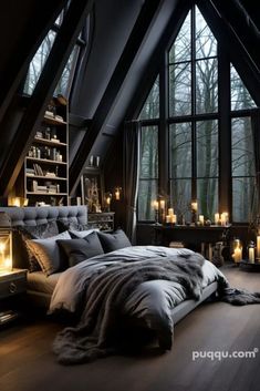 an attic bedroom with large windows and lots of candles