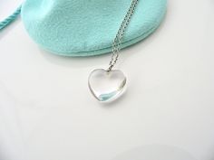 Guys, listen up! Here's a piece that will win the lady's heart! :) Offered for sale is a gorgeous Tiffany and Co. Sterling Silver Crystal Heart necklace. The piece is made from wonderful Tiffany silver that has a smooth, substantial, and yet very feminine feel to it. Hanging from the delicate Tiffany curb chain is a very pretty crystal heart pendant. It is a piece that pretty much goes with anything you can think of putting on ... Great to wear to work, or for just going to dinner with friends i Crystal Heart Necklace, Crystal Heart Pendant, Charm Chain, Puffed Heart, Dinner With Friends, Chain Silver, Tiffany And Co, Gift Pouch, Silver Crystal