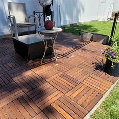 an outdoor patio area with chairs, table and grill