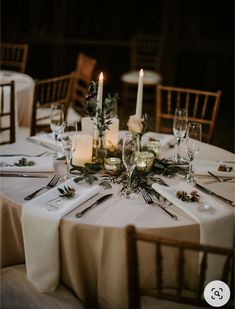 the table is set with candles and place settings