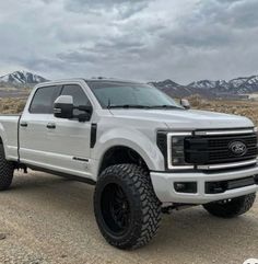 a white truck is parked in the desert