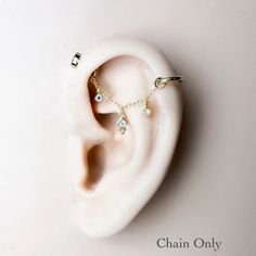 a pair of ear piercings on top of a white surface