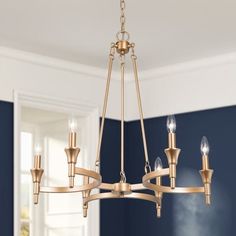 a chandelier hanging in a room with blue walls