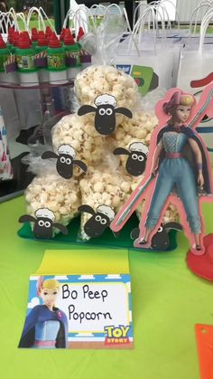 a table topped with lots of popcorn covered in cartoon character figurines and decorations