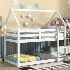 a white bunk bed sitting in a bedroom next to a wall mounted clock with stars on it