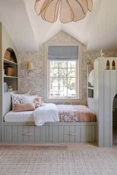 a room with a bed, bookcases and a window in the ceiling area