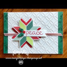 a close up of a card with the word peace on it and an ornament