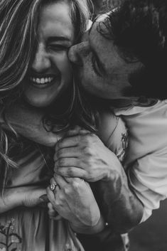 black and white photograph of a man kissing a woman