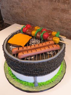 a cake with hot dogs and cheese on it