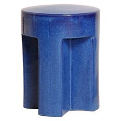 a blue stool that is sitting on a white surface