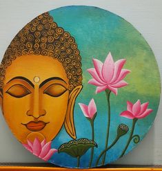 there is a painting on the wall with flowers and buddha face in front of it