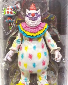 a toy clown with multicolored polka dots on it's body