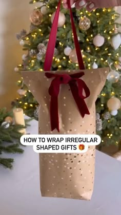 a bag hanging from a christmas tree with the words how to wrap irregular shaped gifts